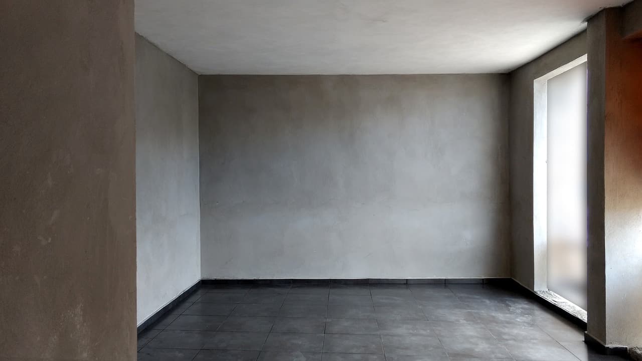 Empty room with freshly plastered walls still drying